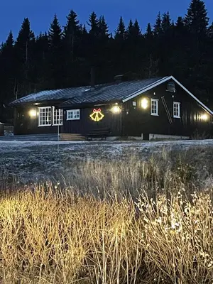 a barn with a sign on the side of it at night at Mountain cabin in Lillehammer in Lillehammer
