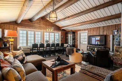 a living room with couches and chairs and a television at Trysilfjell hytteomrade 589 in Hovi