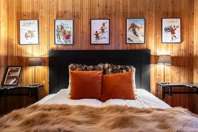 a bedroom with a bed and some pictures on the wall at Trysilfjell hytteomrade 589 in Hovi