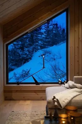 a room with a large window with a view of a mountain at FJELLRO Private Alpine Lodge Høgevarde in Flå