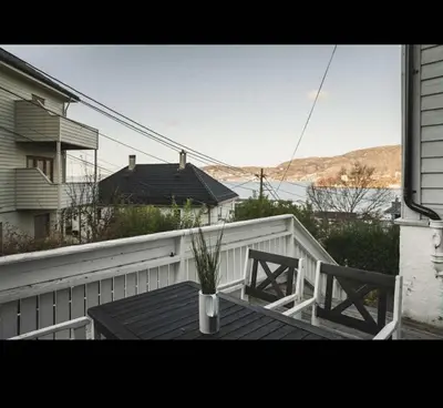 a balcony with a table and two chairs on a porch at Bright and modern apartment close to the city center! 2 bedroom in Bergen