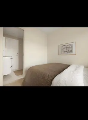 a bedroom with a bed and a bathroom at Bright and modern apartment close to the city center! 2 bedroom in Bergen