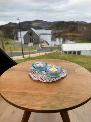 two dishes on a table with a candle on it at Langelandsvik Gard Birdbox