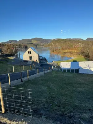 arial view of a farm with a body of water at Langelandsvik Gard Birdbox