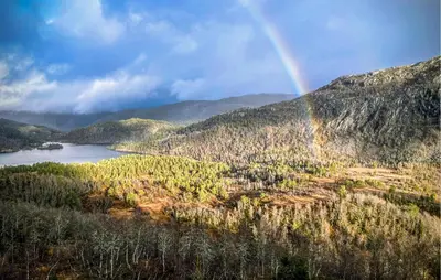 a rainbow over a mountain range with a lake at 3 Bedroom Beautiful Apartment In Voss in Vossevangen
