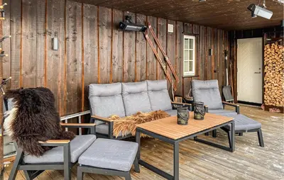 a living room with chairs and a table and a dog at Stunning Home In Bjorli With Sauna in Bjorli