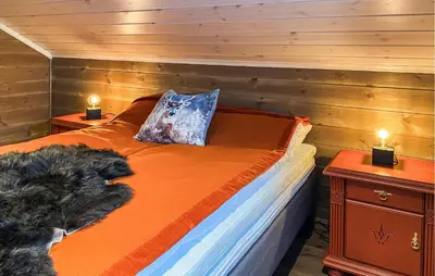a bedroom with a bed with two night stands and two lamps at Stunning Home In Bjorli With Sauna in Bjorli