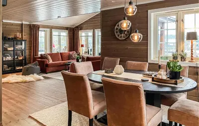 a living room with a table and chairs at Stunning Home In Bjorli With Sauna in Bjorli