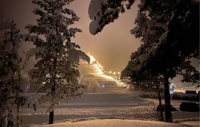 a snow covered street with a baseball stadium in the distance at Amazing Apartment In Bjorli With Wifi in Bjorli