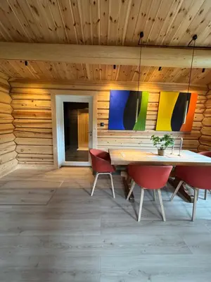 a dining room with a table and red chairs at Gunhild-stugu
