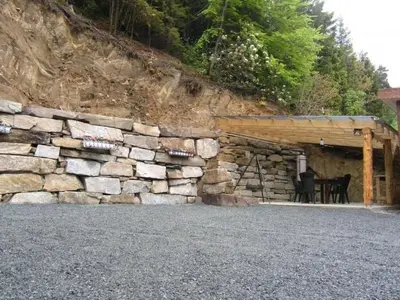 a stone wall with a table in front of a building at Apartment Fw Franzi by Interhome in Hagavik