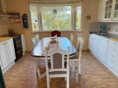 a kitchen with a table and chairs in it at Holiday Home Stabben white House by Interhome in Aure