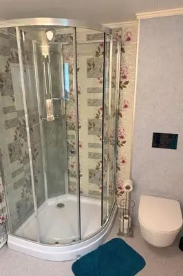 a shower in a bathroom with a toilet at Holiday Home Stabben Blue House by Interhome in Storsæter