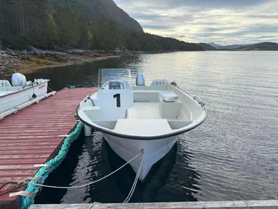 a boat docked at a dock in the water at Holiday Home Stabben Blue House by Interhome in Storsæter