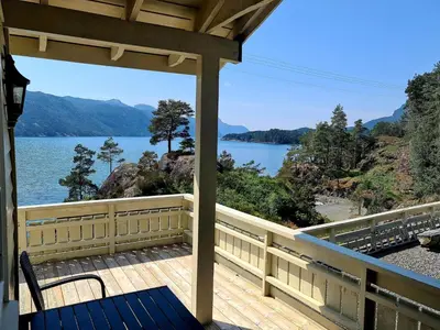 a porch with a view of a lake at Holiday Home mit Blick auf das Wasser by Interhome in Hebnes
