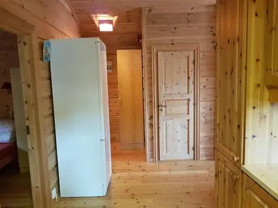 a white refrigerator in a room with a door at Holiday Home Ein Traumstandort by Interhome in Hebnes