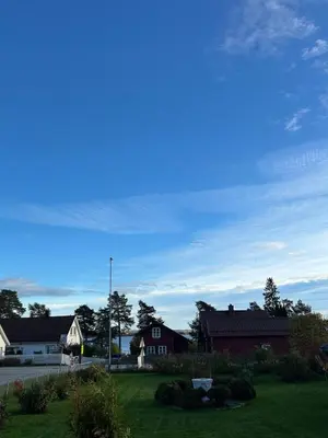 a view of a yard with houses and a blue sky at Great house Hamar, stay close to Mjøsa at Domkirkeodden in Hamar
