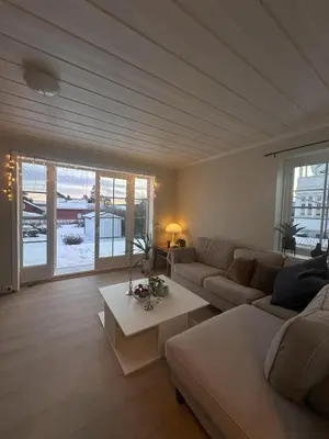 a living room with a couch and a table at Great house Hamar, stay close to Mjøsa at Domkirkeodden in Hamar