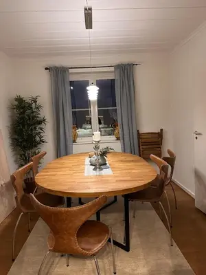 a dining room with a wooden table and chairs at Great house Hamar, stay close to Mjøsa at Domkirkeodden in Hamar