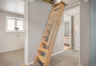 a wooden ladder in a room with a wall at Exclusive mountain cabin - Panoramic views in Vossevangen