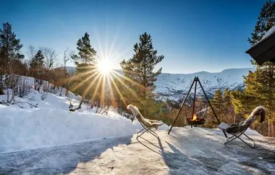 two birds on a swing in the snow at Exclusive mountain cabin - Panoramic views in Vossevangen