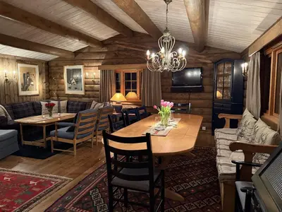 a dining room with a wooden table and chairs at Large cottage with beautiful view in Trysil in Trysil