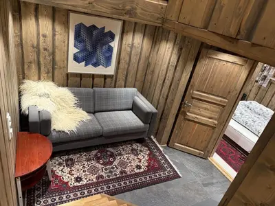 a living room with a couch and a bed at Large cottage with beautiful view in Trysil in Trysil