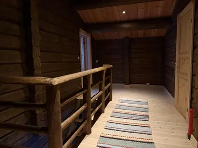 a room in a log cabin with a bed and a rug at Cabin at Fageråsen - 4 roomed family cabin for skiing in Trysil in Trysil