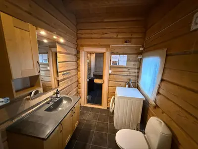 a bathroom with a sink and a toilet in a log cabin at Cabin at Fageråsen - 4 roomed family cabin for skiing in Trysil in Trysil