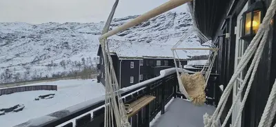 a balcony of a building with a snow covered mountain at Apartment Røldalsfjellet in Håra