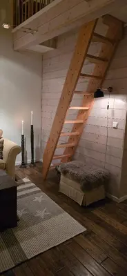 a room with a loft with a ladder and a bed at Apartment Røldalsfjellet in Håra