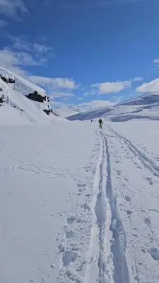 a person walking across a snow covered field at Apartment Røldalsfjellet in Håra