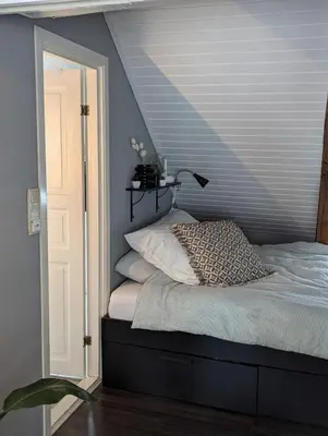 a bedroom with a bed with a lamp on it at Apartment centrally located in Trondheim in Trondheim