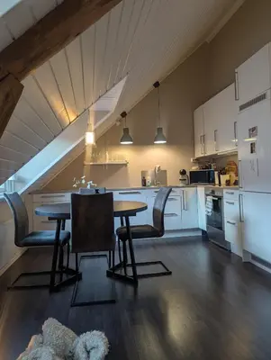 a kitchen with a table and chairs in a room at Apartment centrally located in Trondheim in Trondheim