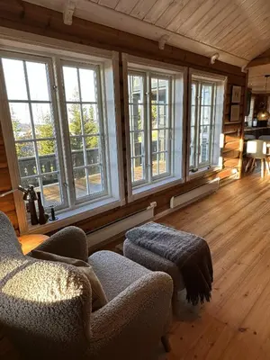 a living room with a couch and some windows at Exclusive family cabin in Hafjell ski-in-ski-out in Hafjell