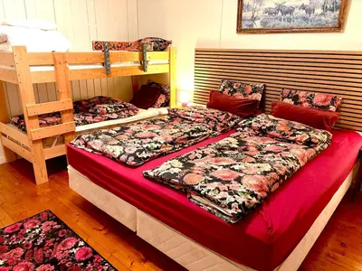 a bedroom with two bunk beds with red sheets at Magic Cabin by Lake & Forest , Peace, Views & Outdoor Fun, in Opphus