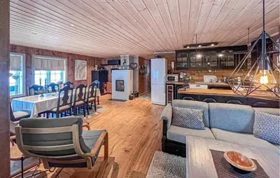 a living room with a couch and a kitchen at Awesome Home In Gålå With Sauna in Gålå