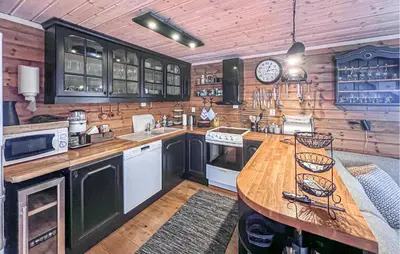 a kitchen with wooden walls and a wooden counter top at Awesome Home In Gålå With Sauna in Gålå