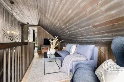a living room with a blue couch and a table at New and great cabin at the foot of Norefjell in Noresund