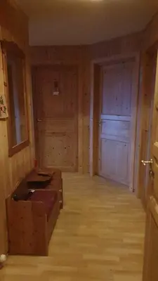an empty room with a wooden floor and a door at Idyllic house on a farm in Steinkjer