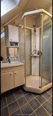 a glass shower in a kitchen with a sink at Central Stay Odda in Odda