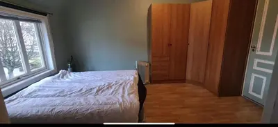 a bedroom with a white bed and a window at Central Stay Odda in Odda