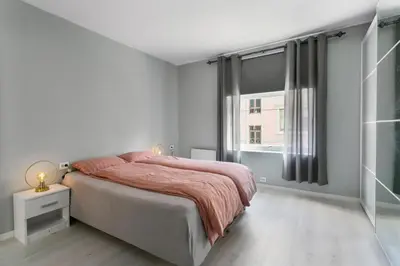 a bedroom with a large bed and a window at Centrum apartment 2 in Ålesund