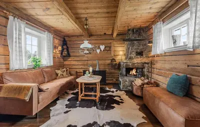 a living room with a couch and a fireplace at 2 Bedroom Gorgeous Home In Svingvoll in Svingvoll