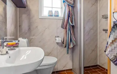 a bathroom with a sink and a toilet and a window at 2 Bedroom Gorgeous Home In Svingvoll in Svingvoll