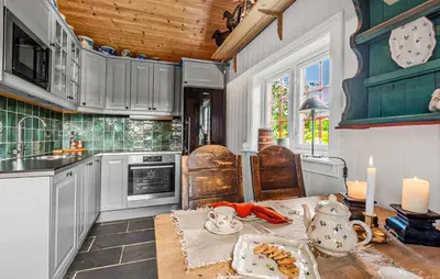 a kitchen with a table with a tea set on it at 2 Bedroom Gorgeous Home In Svingvoll in Svingvoll