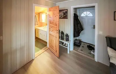 a bathroom with a door open to a bathroom with a sink at 2 Bedroom Awesome Home In Vanvikan in Vannvikan