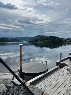 a dock with a boat on the water at Amundøya Seaside in Kristiansund