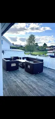 a group of benches sitting on top of a deck at Koselig bolig med stor stue, 10 min from Solsiden! in Trondheim