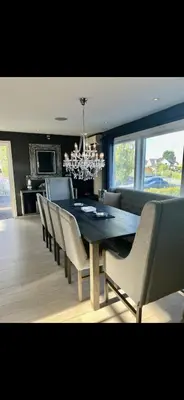 a dining room with a black table and chairs at Koselig bolig med stor stue, 10 min from Solsiden! in Trondheim